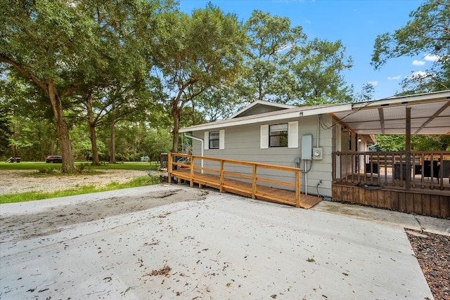 view of property exterior featuring a wooden deck