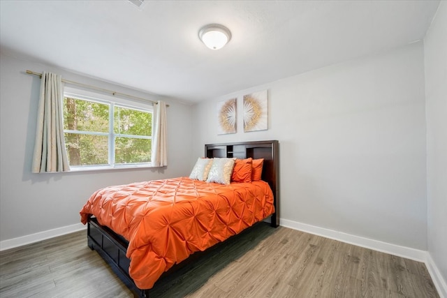 bedroom with hardwood / wood-style flooring