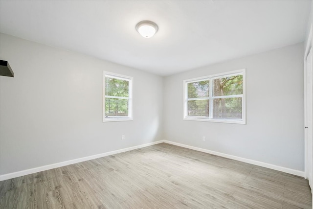 spare room with hardwood / wood-style floors