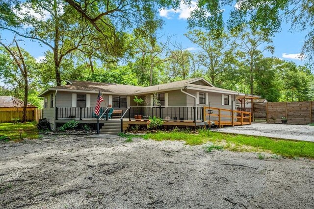 rear view of house featuring a deck