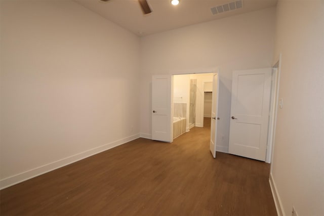 unfurnished room with dark wood-type flooring