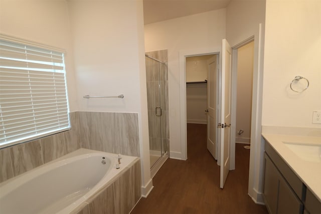 bathroom featuring vanity, plus walk in shower, and hardwood / wood-style floors