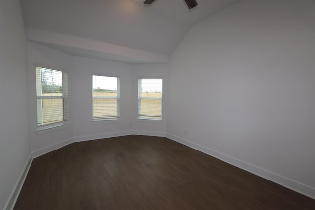 unfurnished room featuring dark wood-type flooring, ceiling fan, vaulted ceiling, and a wealth of natural light