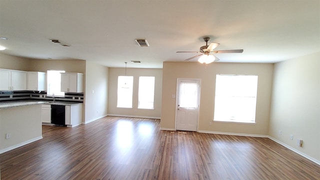 interior space with ceiling fan, dark hardwood / wood-style floors, and sink