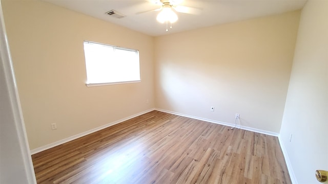 spare room featuring light wood-type flooring and ceiling fan