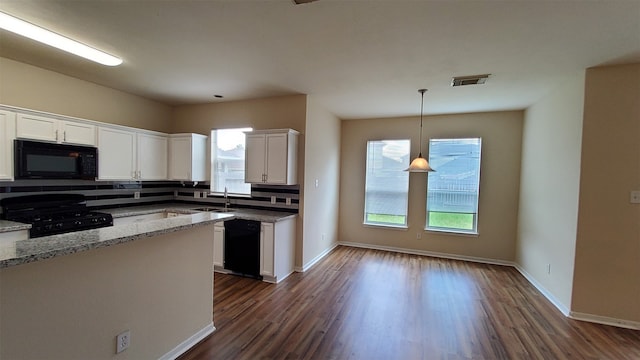 kitchen featuring light stone counters, white cabinetry, dark wood-type flooring, black appliances, and tasteful backsplash