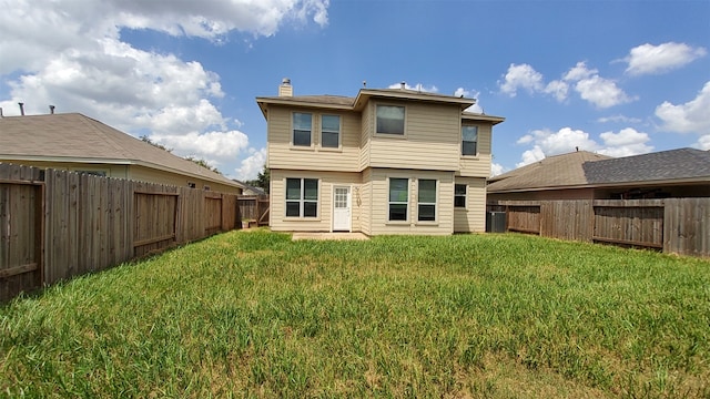 rear view of property with a yard