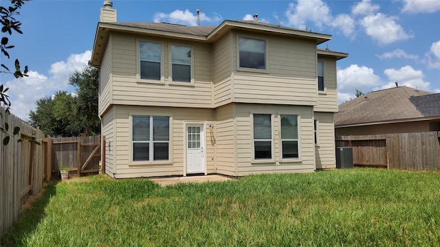 rear view of property featuring a lawn