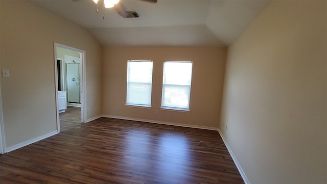 spare room featuring ceiling fan, dark hardwood / wood-style floors, and vaulted ceiling