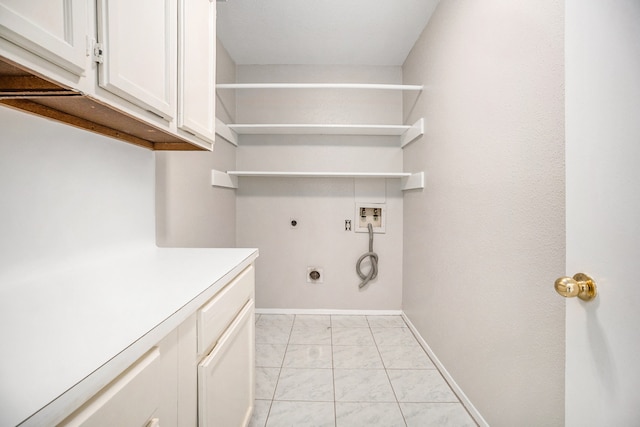 clothes washing area featuring electric dryer hookup, cabinets, and washer hookup