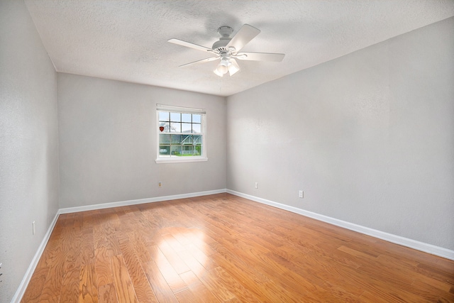 spare room with ceiling fan, a textured ceiling, and light hardwood / wood-style flooring