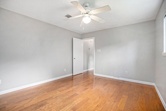 spare room featuring light hardwood / wood-style flooring and ceiling fan