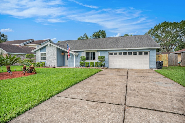 single story home featuring a garage and a front lawn