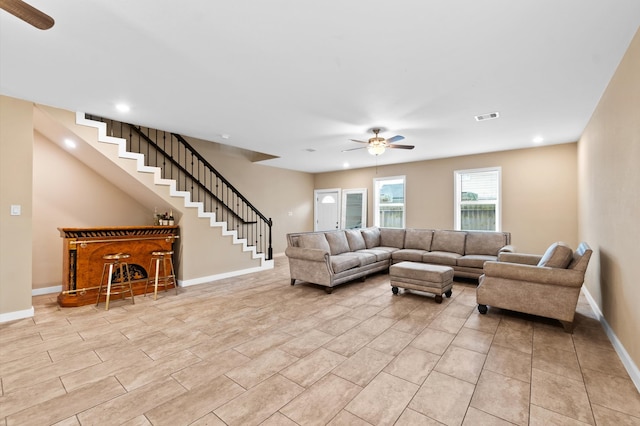 tiled living room with ceiling fan