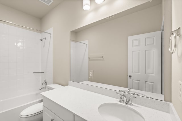 full bathroom featuring tiled shower / bath combo, vanity, and toilet