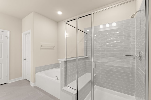 bathroom featuring tile patterned flooring and separate shower and tub