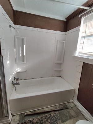 bathroom featuring tile patterned floors and  shower combination