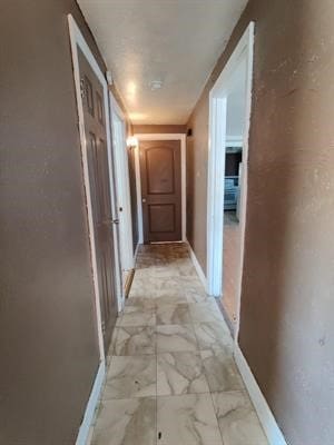 corridor with light tile patterned flooring