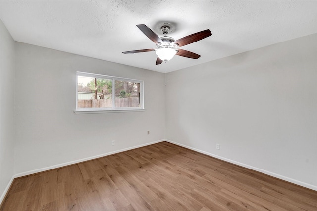 unfurnished room featuring ceiling fan, light hardwood / wood-style flooring, and a textured ceiling