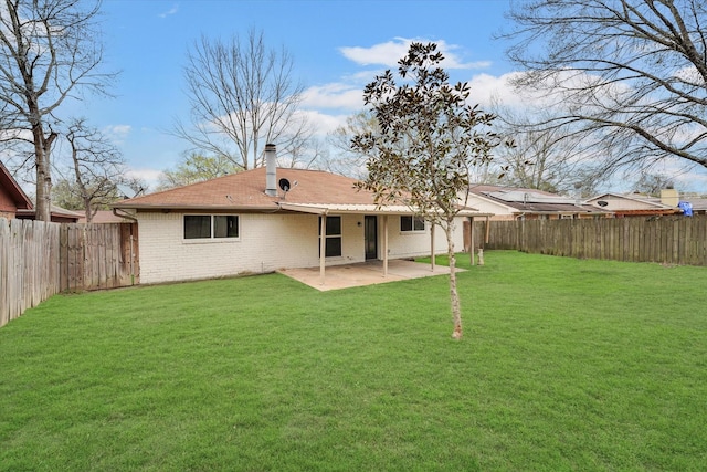 rear view of property with a yard and a patio