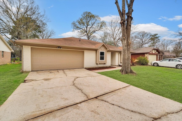 ranch-style house featuring a garage and a front lawn