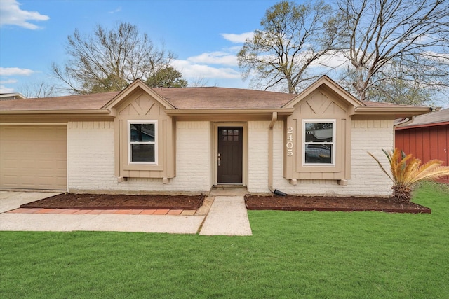 view of front facade with a garage and a front lawn