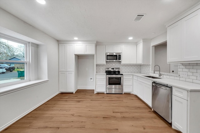 kitchen featuring white cabinetry, appliances with stainless steel finishes, and sink