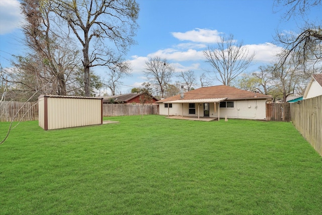 view of yard with a shed and a patio