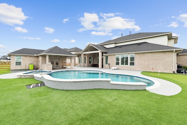 view of swimming pool with an in ground hot tub, a patio area, and a yard