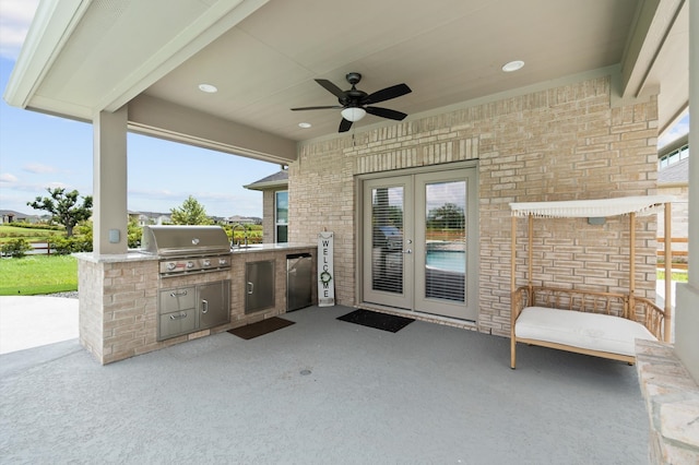 view of patio / terrace featuring french doors, ceiling fan, area for grilling, and an outdoor kitchen