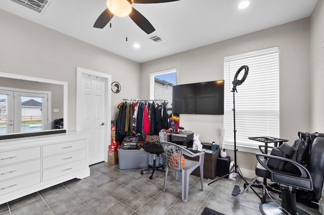 tiled office space with ceiling fan