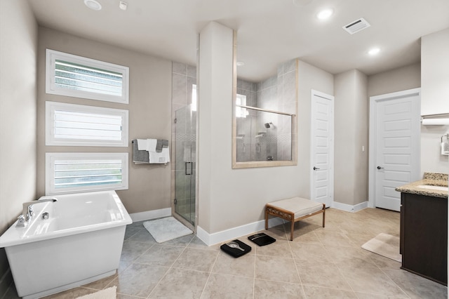 bathroom featuring tile patterned flooring, a healthy amount of sunlight, vanity, and independent shower and bath