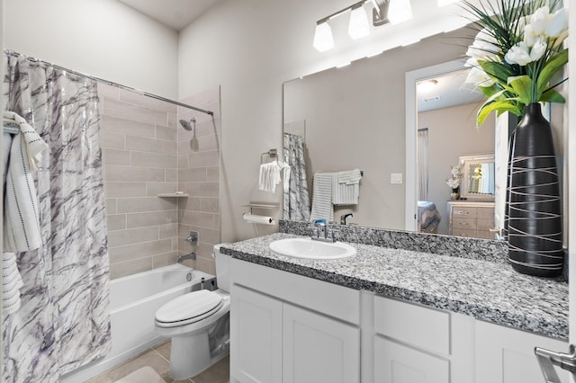 full bathroom featuring tile patterned flooring, shower / bath combo, toilet, and vanity