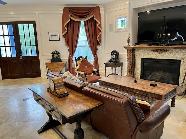 tiled living room with a notable chandelier, a fireplace, french doors, and a healthy amount of sunlight