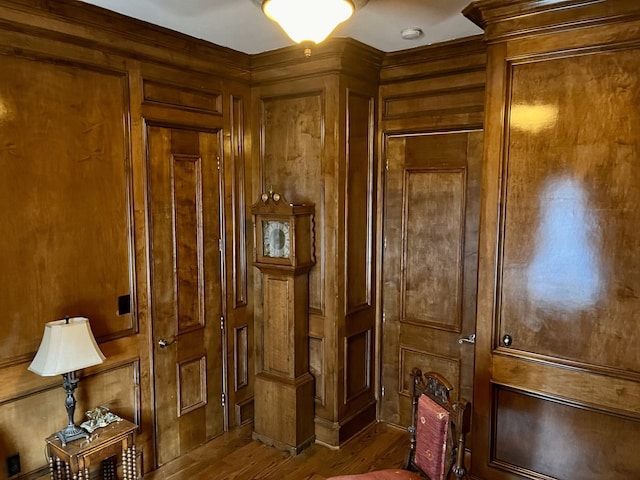 interior space with wood walls and hardwood / wood-style floors