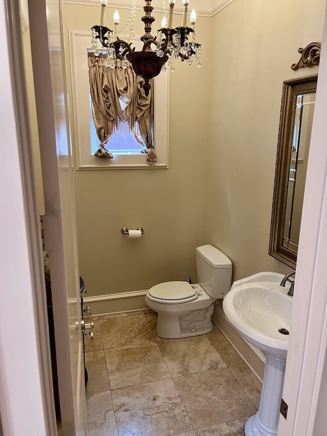 bathroom with toilet, an inviting chandelier, tile patterned flooring, and crown molding