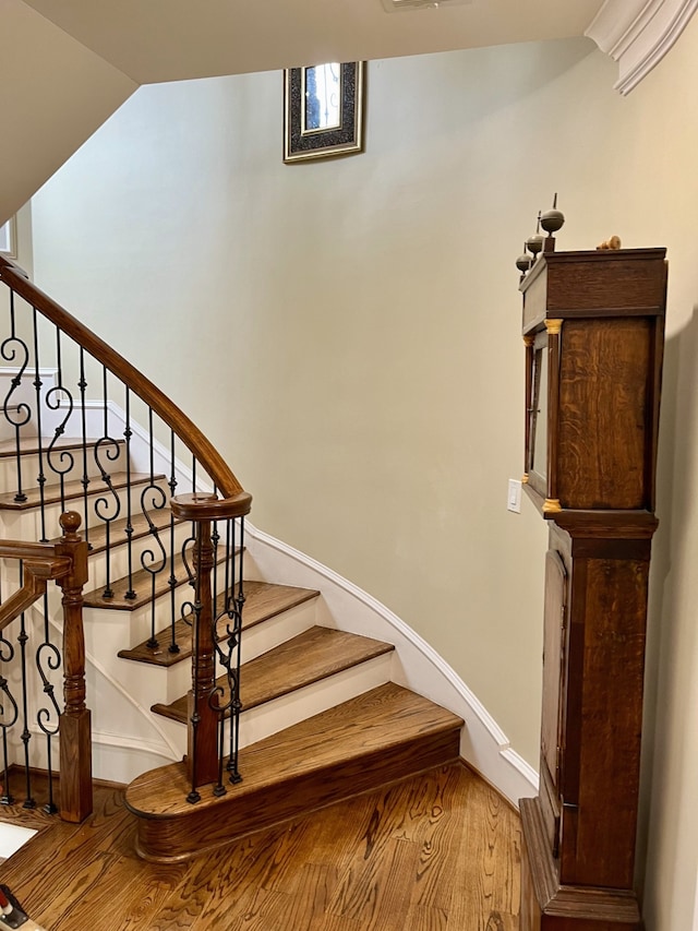 stairway featuring hardwood / wood-style floors