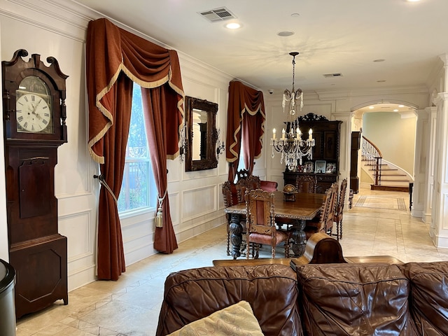 dining room featuring light tile patterned floors, a chandelier, and ornamental molding