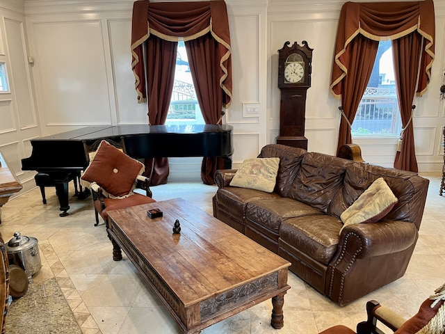 tiled living room featuring crown molding and a wealth of natural light