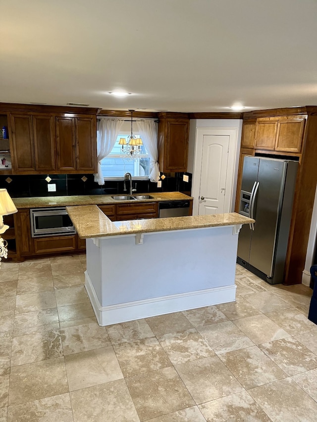 kitchen featuring sink, decorative light fixtures, light tile patterned floors, and stainless steel appliances