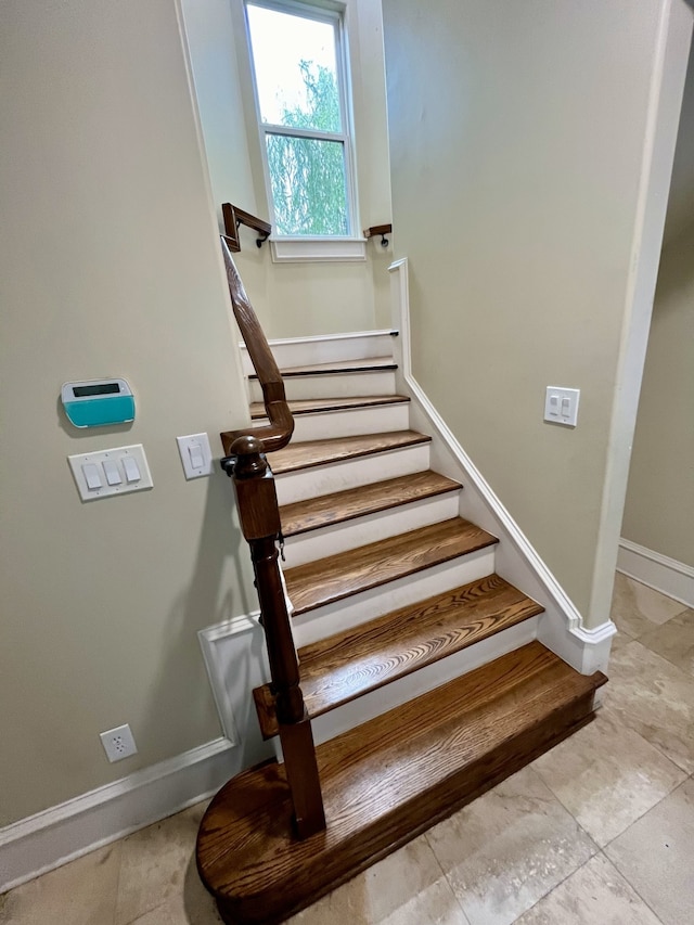 stairway featuring light tile patterned floors