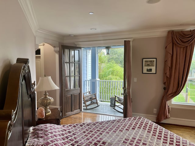 bedroom with crown molding, access to outside, light hardwood / wood-style flooring, and multiple windows