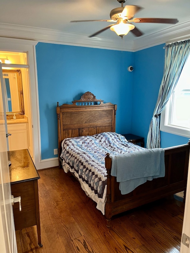 bedroom with hardwood / wood-style flooring, connected bathroom, crown molding, and ceiling fan