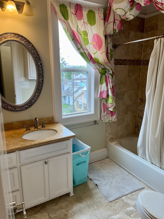 full bathroom featuring tile patterned floors, toilet, vanity, and shower / tub combo with curtain