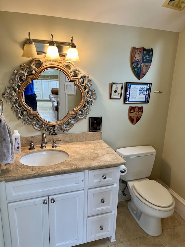 bathroom with vanity, toilet, and tile patterned flooring