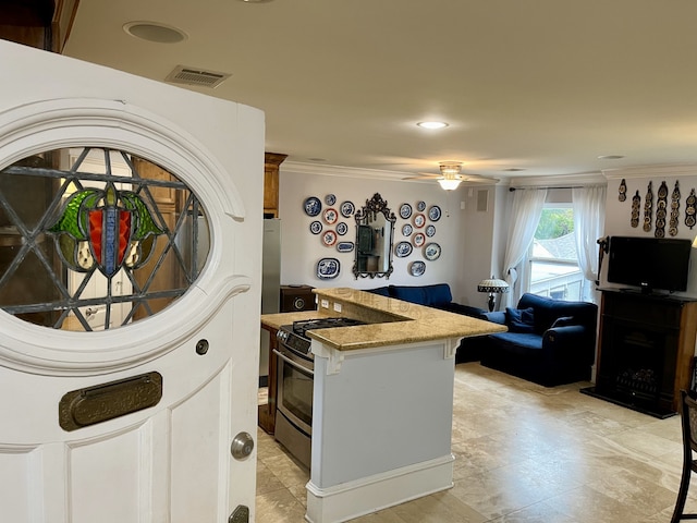 kitchen with light tile patterned flooring, light stone counters, ceiling fan, and stainless steel range with gas cooktop