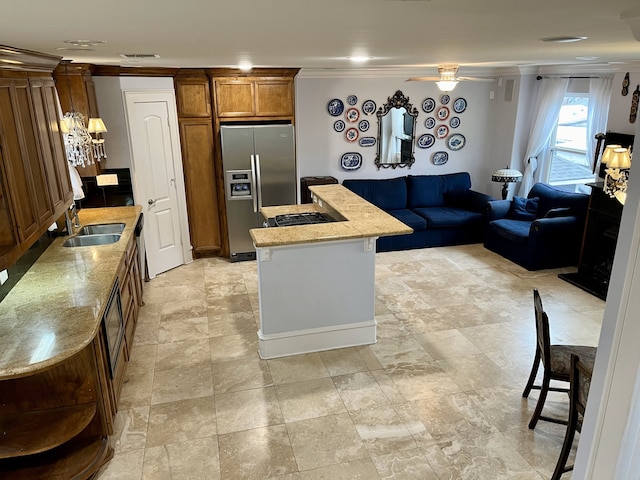 kitchen with stainless steel fridge, sink, light tile patterned floors, and ceiling fan