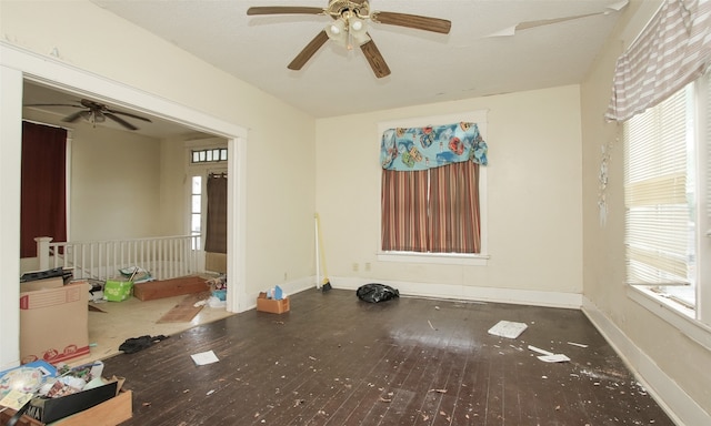 unfurnished room with a wealth of natural light, ceiling fan, and hardwood / wood-style floors