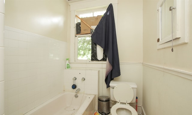 bathroom with toilet and a healthy amount of sunlight