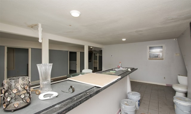 kitchen with tile patterned flooring and a textured ceiling